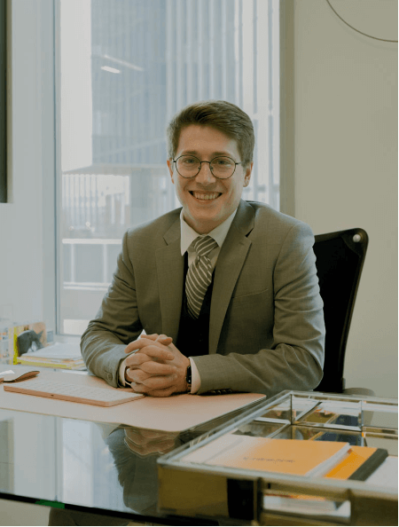 Attorney-sitting-behing-office-desk-smiling